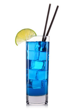 Blue curacao cocktail with lime and cherry in tall glass isolated on white background.