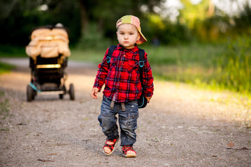 portrait of happy schoolboy with satchel on his back