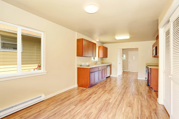 Open floor plan kitchen room interior with wooden cabinets