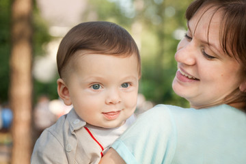 Cute baby boy less 1 year with his mom in summer park
