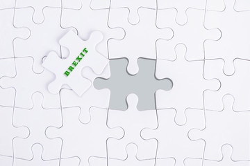 Obraz premium Missing white puzzle with BREXIT word and copyspace area.