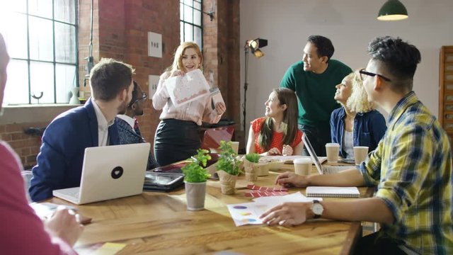  Young hipster business group working & brainstorming for ideas in loft office