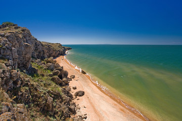 stone cliffs on the coast and blue sky
