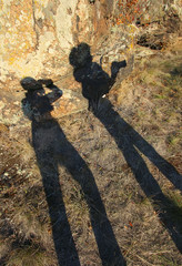 funny shade-pieces on the rocks of two young men with cameras.
