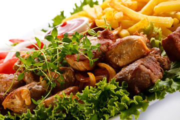 Kebab - grilled meat with French fries and vegetables