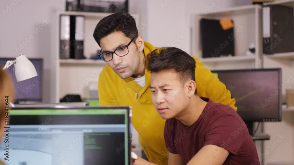 Wall mural young computer experts working in office with lots of computers