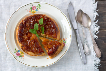 Homemade apple pie with caramel and fresh apples, rustic style, selective focus