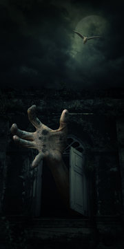 Zombie hand rising out from old ancient window with bird fly ove