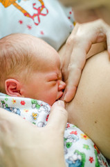 portrait of mother nursing her baby