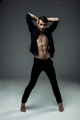 sexy young fashion man wearing a black shirt unbuttoned