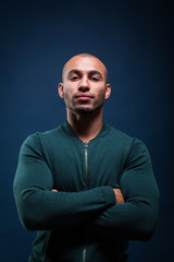 Portrait of an african american man smiling on dark blue background