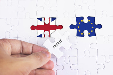 Business Concept - Female hand and missing puzzle with BREXIT word