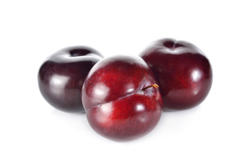 whole ripe plum on white background