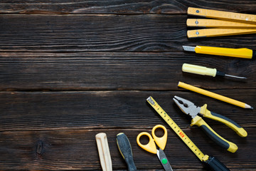 tools for repair and construction in yellow.