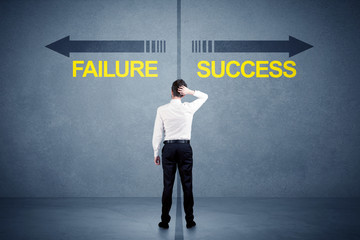 Fototapeta premium Businessman standing in front of success and failure arrow conce