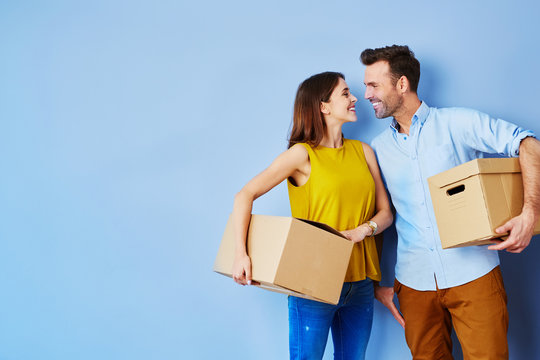 young couple standing together with boxes