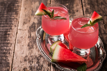 Watermelon drink in glasses with slices of watermelon mint and lemon, vintage background ,soft focus