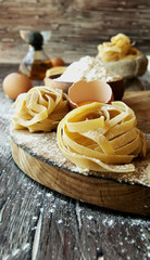 Uncooked pasta with flour on the table, selective focus