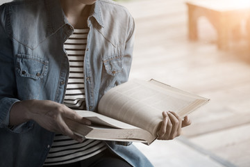 Fototapeta premium vintage photo of woman reading text book in library.
