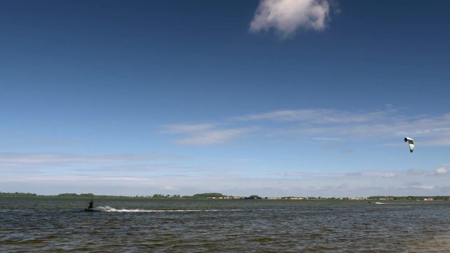 Kite Surfing in Ocean, Extreme summer sport. Kite Boarding in Baltic Sea. Clip contains: kitesurfing, kiteboarding, ruegen, water, surfer, beach	
