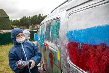 Children painting retro car in different colors