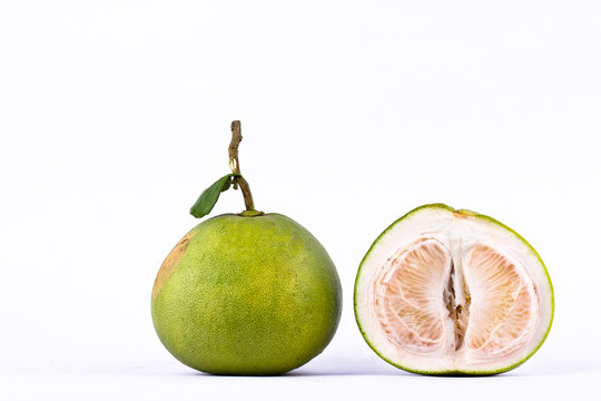 fresh green pomelos and half  pomelo peeled on white background healthy fruit food isolated
