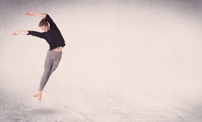 Fototapeta premium Modern ballet dancer performing art jump with empty background