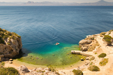 Aerial view of perachora's Ireon lake in Greece. Beautiful crystal clear sea with a boat in it.
