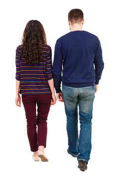 Back view going couple. walking friendly girl and guy holding hands. Rear view people collection. backside view of person. Isolated over white background. Swarthy girl and a bearded man thoughtfully