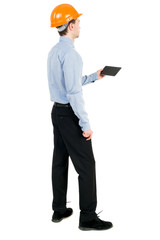Backview of business man in construction helmet stands and enjoys tablet or using a mobile phone. Standing young guy. Rear view people collection.  backside view of person.  Isolated over white