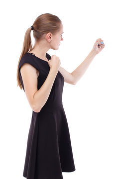 skinny woman funny fights waving his arms and legs. Isolated over white background. Blonde in a short black dress clenched her fists.