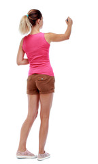 back view of writing beautiful woman. Rear view people collection.  backside view of person. Isolated over white background. Sport blond in brown shorts writes on the blackboard.