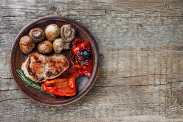 grilled meat and vegetables on the plate top view