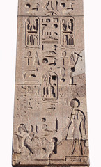 Hieroglyph script on ancient egyptian obelisk in the center of Piazza del Popolo square, Rome