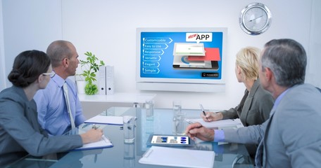 Composite image of business team looking at time clock 