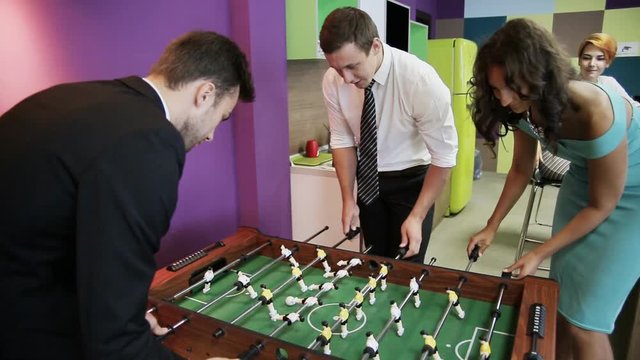 Office workers playing kicker