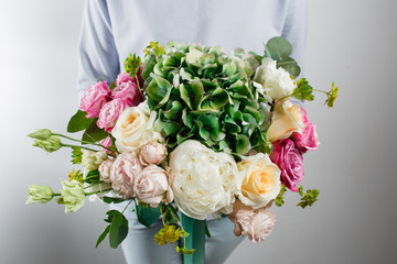 flower composition with hydrangea and peonies. Color pink, green, lavander, blue. Kraft paper. crisp packaging