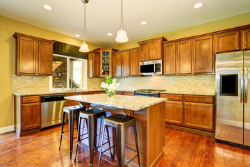 Wooden kitchen interior with kitchen island and cabinets.