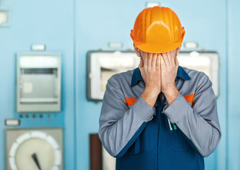 stressed engineer closed face by two hands