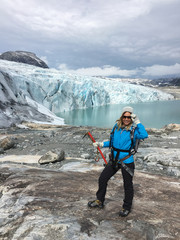 Woman climber standing near Jostedalsbreen glacier.