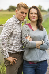 couple standing outdoors and looking at camera