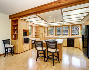 Kitchen room interior with wooden cabinets, island and hardwood floor