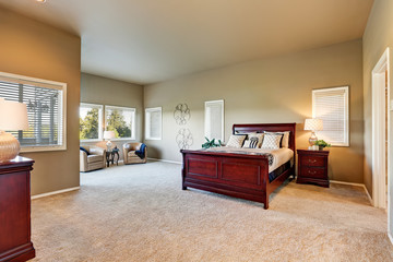 Bedroom interior with beige walls and cherry wooden furniture