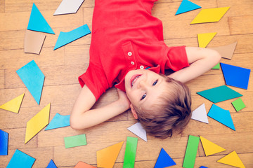 happy little boy with puzzle toys, early learning