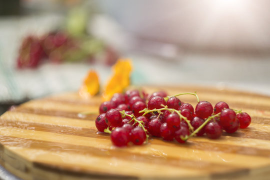 Red currants on a wooden board