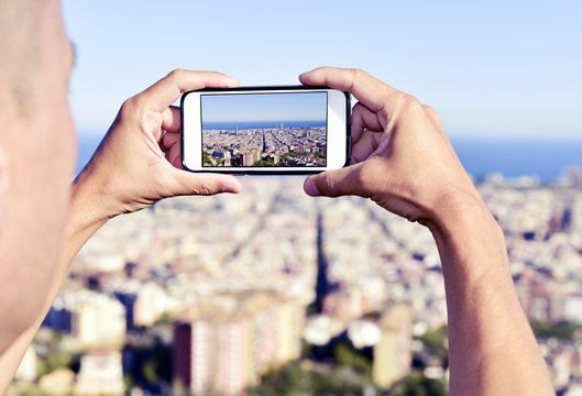 man taking a picture of Barcelona, Spain, from above