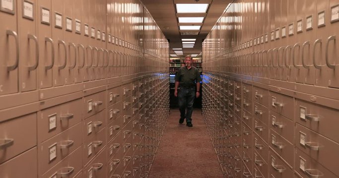 Man search Microfilm storage Genealogy LDS Church Utah. Church of Jesus Christ of Latter-day Saints or Mormon Church Headquarters. Largest genealogical collection in world resources.