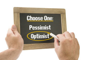 Hand choose Optimist on chalkboard