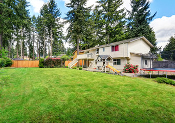 View of kids playground in green backyard garden