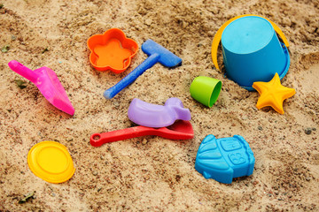 Fototapeta na wymiar children's toys in the sandbox